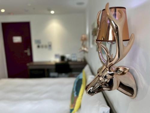 a metal object hanging on a wall next to a bed at Norway Forest Travel hotel 1 Taichung in Taichung