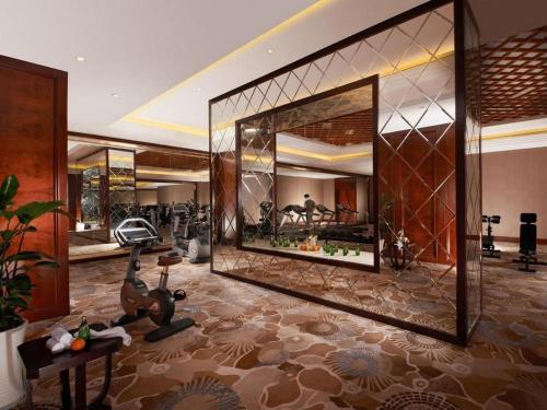 a room with a gym with a large mirror at Dongwu New Century Grand Hotel Huzhou in Huzhou