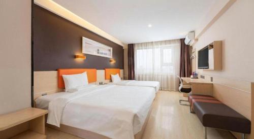 a hotel room with a large bed and a television at 7 Days Premium· Zhoushuizi Airport Wal-Mart in Dalian