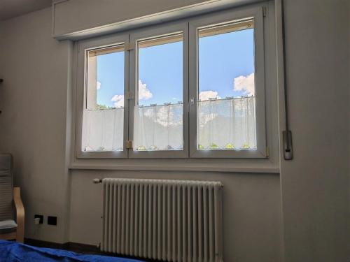 a window in a room with a radiator at "Casa Lucchinetti" full apartment in Piuro in Prosto di Piuro