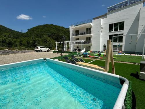 a large swimming pool in front of a building at Vila AMAZON in Dubova