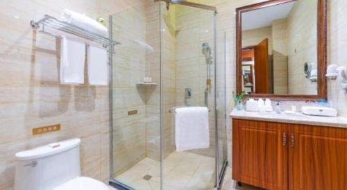 a bathroom with a shower and a toilet and a sink at YUN-RAY Hotel Shijiazhuang in Shijiazhuang