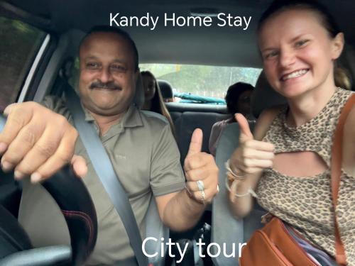 a man and a woman giving thumbs up in a car at Kandy Home stay in Katugastota