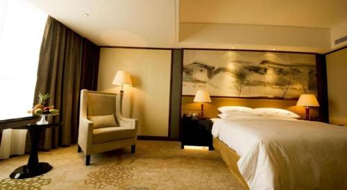 Ένα ή περισσότερα κρεβάτια σε δωμάτιο στο Yang Peng Jin Jiang Hotel
