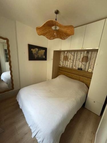 - une chambre avec un lit blanc et un ventilateur dans l'établissement Charmant duplex au coeur du centre historique, à Bordeaux