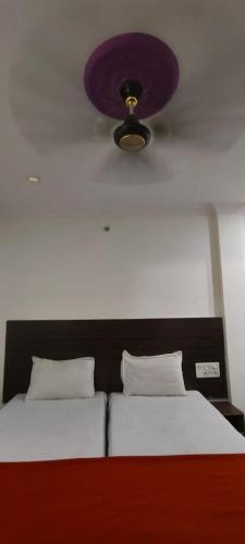 a bedroom with a bed with a purple ceiling at HoTEL SRI BRUNDAVAN in Vijayawāda
