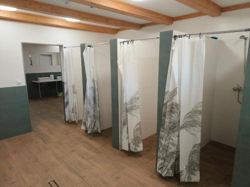 a row of shower stalls in a room at Słoneczne Przyczepy Dębki in Dębki