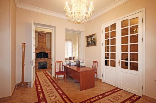 a home office with a desk and a chandelier at Bridge House Yerevan Armenia in Yerevan