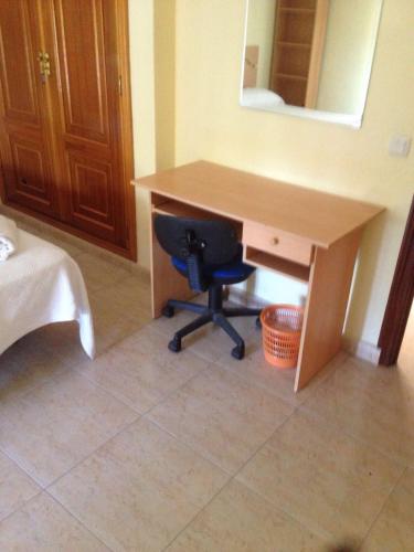 a desk with a chair and a desk with a mirror at Hostal Jose Luis in Brunete