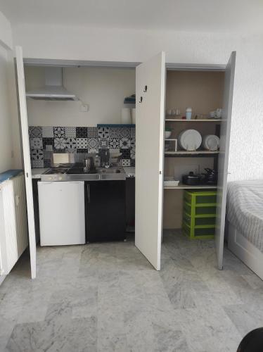 une petite cuisine avec évier et une chambre dans l'établissement Beautiful apartment, sea, air conditioning, internet, à Antibes