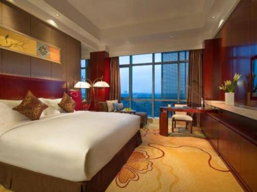 a bedroom with a large bed and a large window at Xi'an Airport Hotel in Xi'an