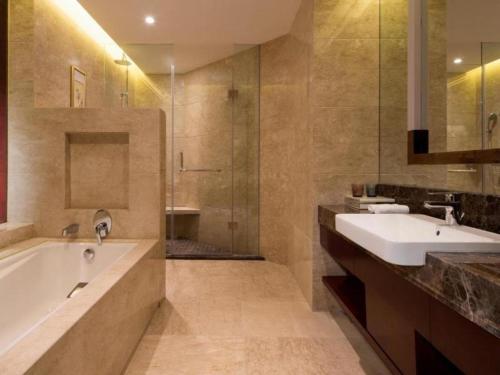 a bathroom with two sinks and a tub and a shower at Xi'an Airport Hotel in Xi'an