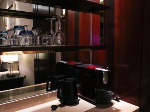 a room with two coffee makers on a shelf at Xi'an Airport Hotel in Xi'an