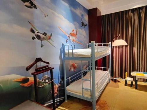 a bedroom with two bunk beds with planes on the wall at Xi'an Airport Hotel in Xi'an