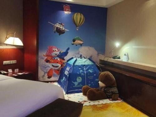 a group of stuffed animals sitting in a bedroom at Xi'an Airport Hotel in Xi'an