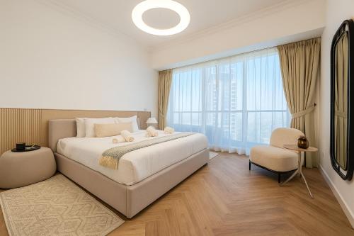 a bedroom with a large bed and a large window at New Renovated Stylish 1 Br Dubai View 73 Floor in Dubai