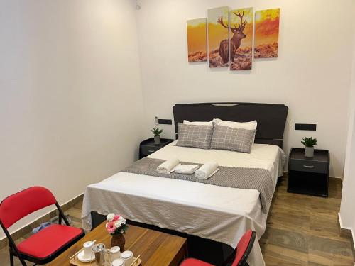 a bedroom with a bed and a table with chairs at RW Homestay in Wegala
