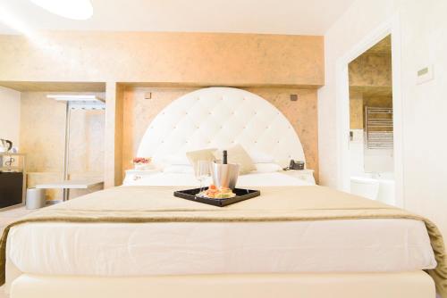a bedroom with a bed with a tray of food on it at Hotel Vespasiano in Rome
