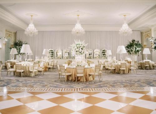 a banquet hall with tables and chairs and chandeliers at Waldorf Astoria Washington DC in Washington