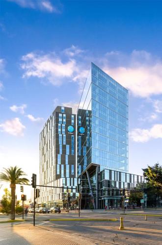 a tall glass building on a city street at Tru By Hilton Chillan Ferrat in Chillán