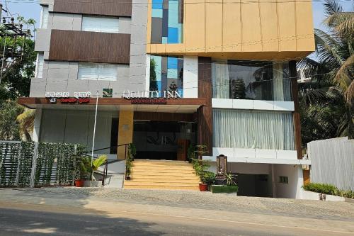 a building with a staircase in front of it at Quality Inn Rockwell Grand, Bangalore in Bengaluru