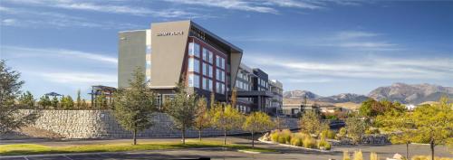 a rendering of a building with mountains in the background at Hyatt Place Reno in Reno