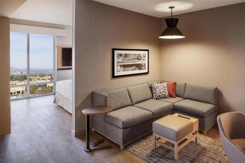 a living room with a couch and a bed at Hyatt Place Reno in Reno