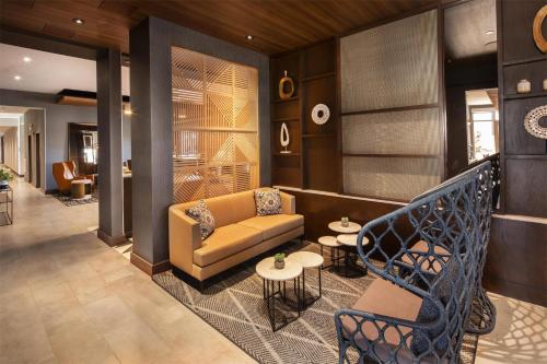 a lobby with a couch and a table and chairs at Hyatt Place Reno in Reno