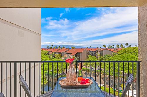 a balcony with a table with a vase of flowers at Kaanapali Shores Studio #642 in Lahaina