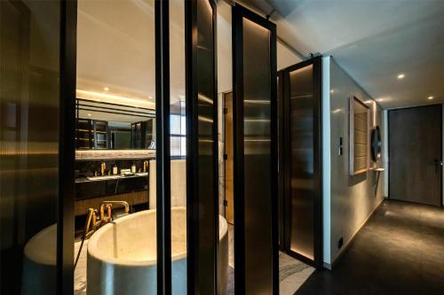 a bathroom with a bath tub in a room at Park Hyatt Johannesburg in Johannesburg