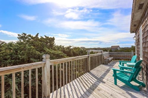 a deck with two green chairs on it at 8074 - Sea Glass Charmer in Avon