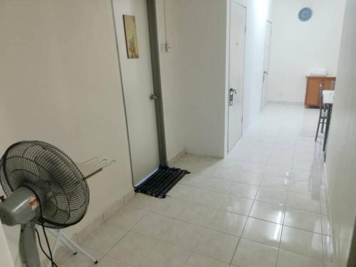 a white hallway with a fan in a room at Cool memories smart stay in Tanah Rata