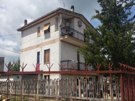 a white house with a fence in front of it at A Casa Mia in Albano Laziale