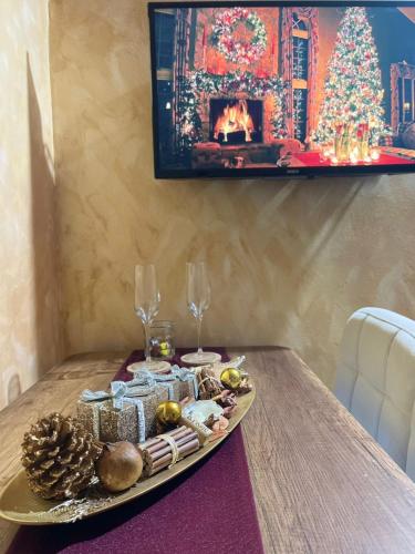 a tray of christmas food on a table with a fireplace at Sorelle Apartment in Tivat