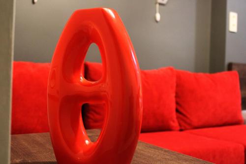 a large red object sitting on a table next to a couch at Studio rooms on the 2nd Floor in Yerevan