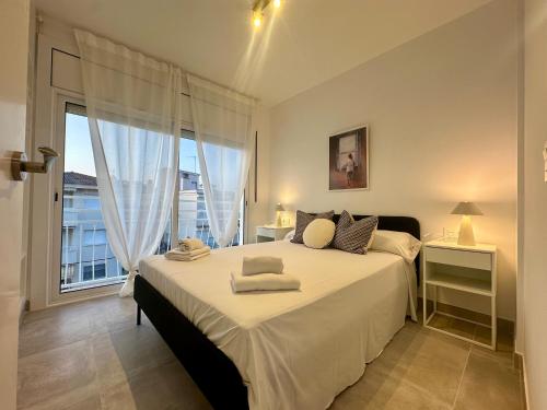 a bedroom with a large bed and a large window at Sea Views Sanatori Beach Deluxe, Barcelona in Calafell