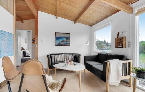 a living room with a couch and a table at Pet Friendly Home In Thisted With Wifi in Torsted