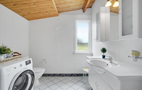 a white bathroom with a washing machine in it at Pet Friendly Home In Thisted With Wifi in Torsted
