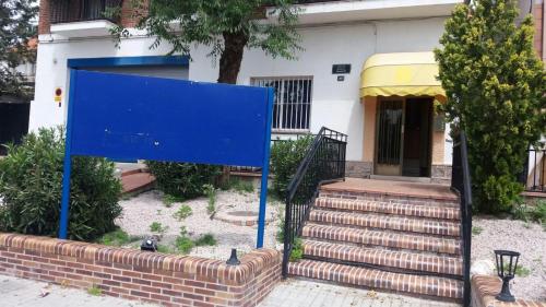 a blue sign in front of a house at Hostal Jose Luis in Brunete