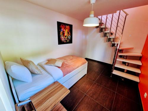 a bedroom with a bed next to a staircase at Stay atLinda's - Calm & peaceful in Eischen