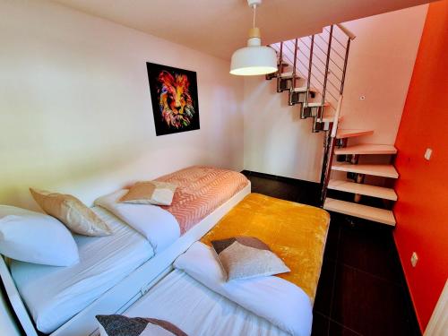 two beds in a room with a staircase at Stay atLinda's - Calm & peaceful in Eischen