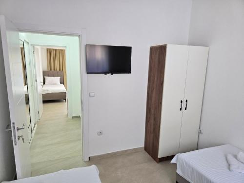 a room with a bedroom with a tv on the wall at Apartments Duga Ulcinj in Ulcinj