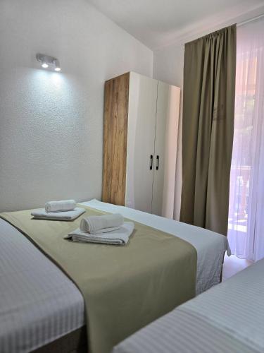 a room with two beds with towels on them at Apartments Duga Ulcinj in Ulcinj