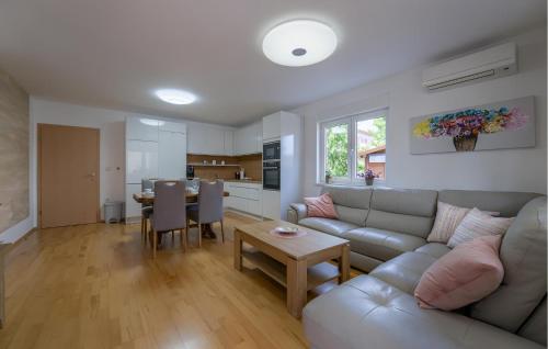 a living room with a couch and a table at Cozy Apartment In Fazana With Wifi in Fažana