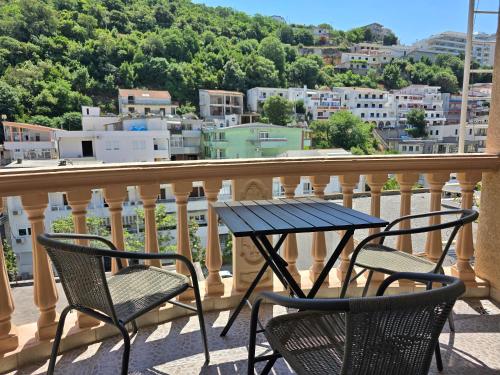 a table and chairs on a balcony with a view at Apartments Duga Ulcinj in Ulcinj