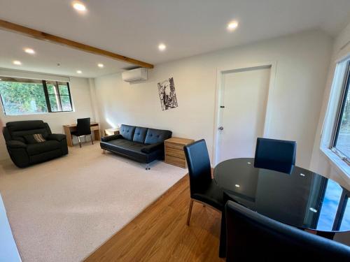 a living room with a table and a couch at Havelock Haven in Havelock