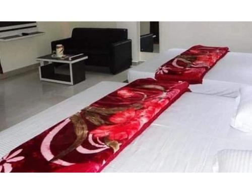 a large bed in a living room with a couch at sri sai hotel deoghar in Deoghar