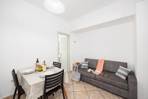 a living room with a table and a couch at Kosmas Apartments in Roda