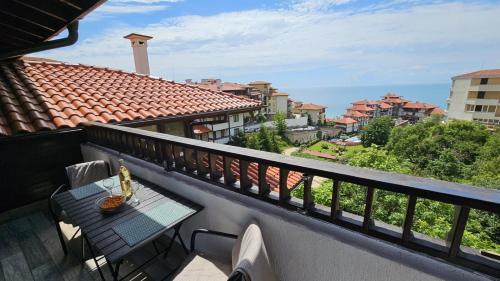 a balcony with a table and a view of the ocean at PSB Apartments in Etara 2 & 3 Complex Sveti Vlas in Sveti Vlas