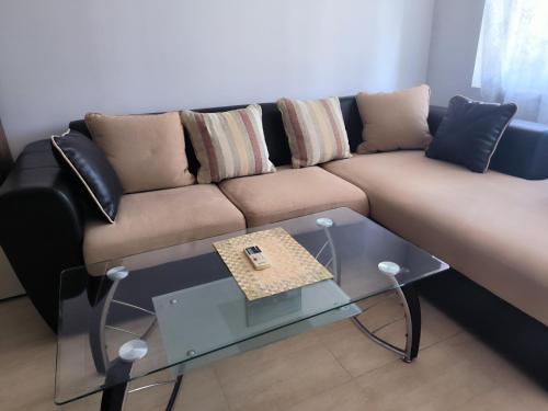 a living room with a couch and a glass table at PSB Apartments in Etara 2 & 3 Complex Sveti Vlas in Sveti Vlas
